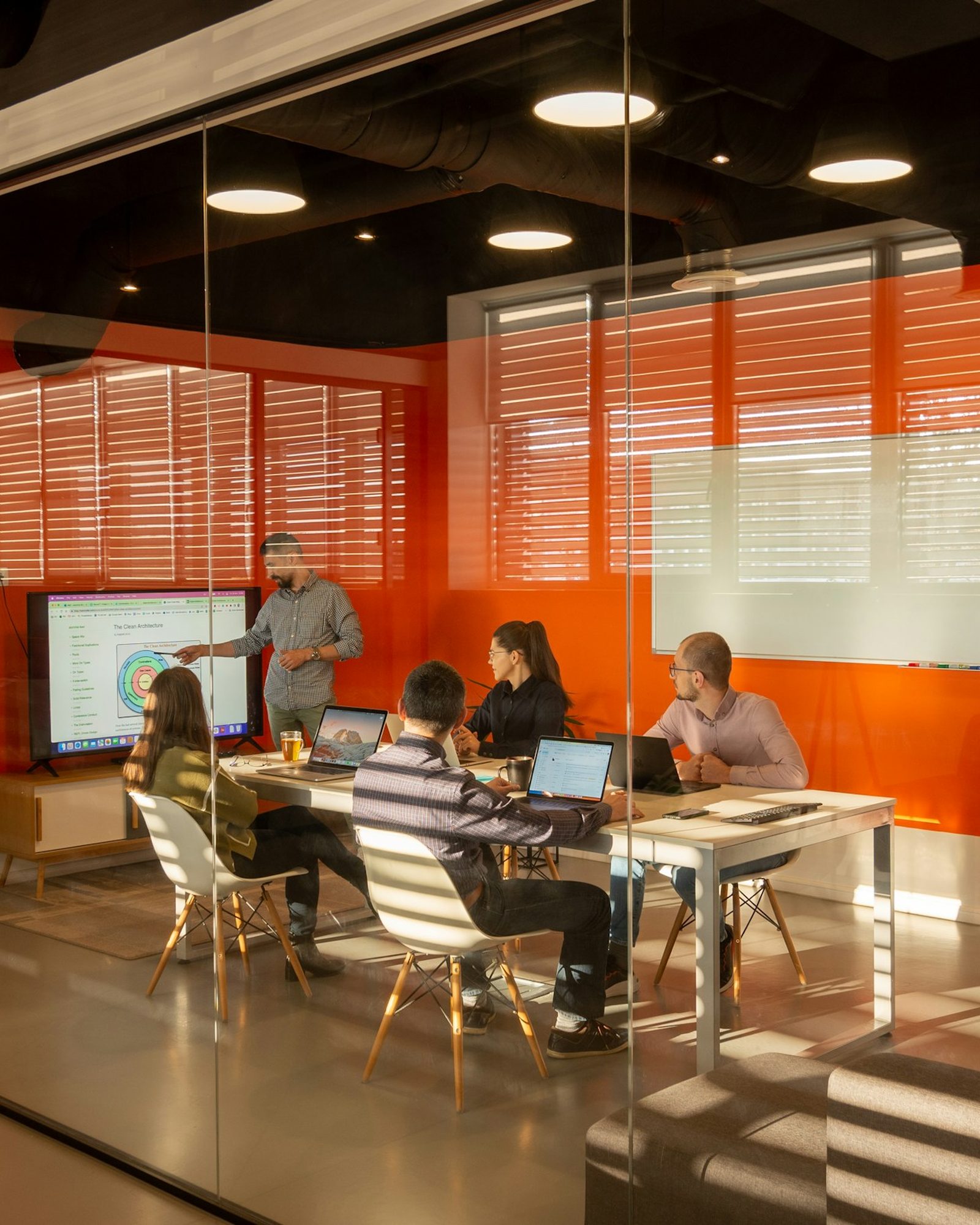 A meeting under way in a glass-walled conference room